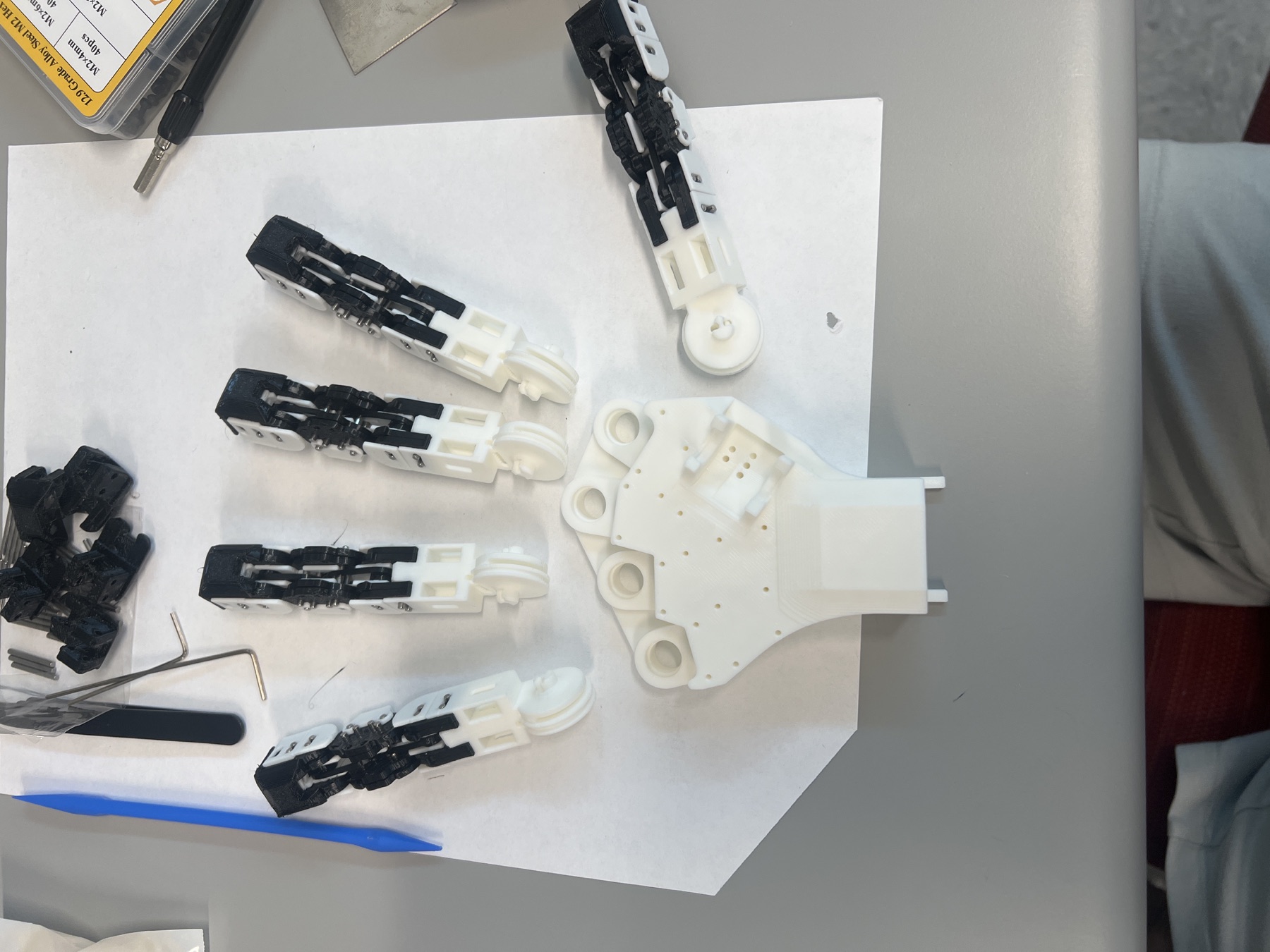 CRAFT finger modules laid out around the palm plate before final assembly